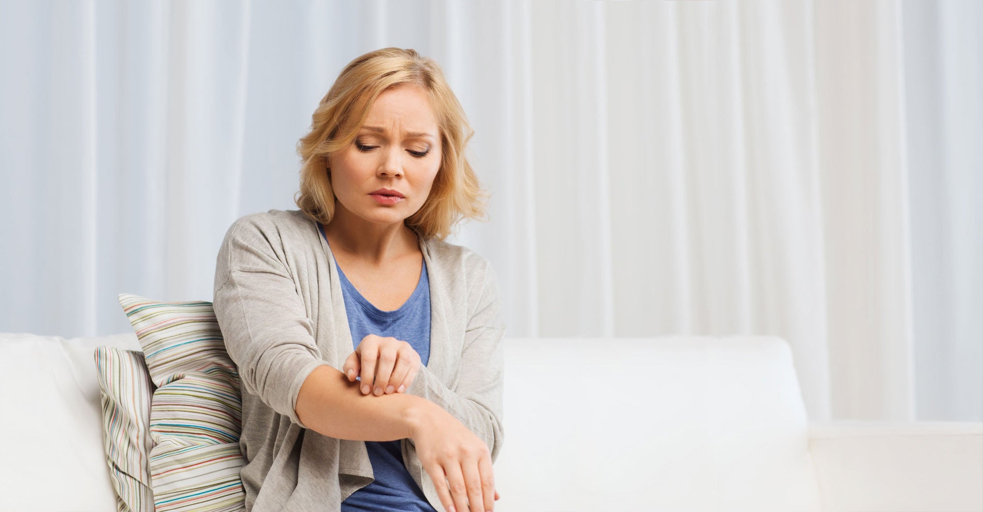 Lady touching arm with dry skin