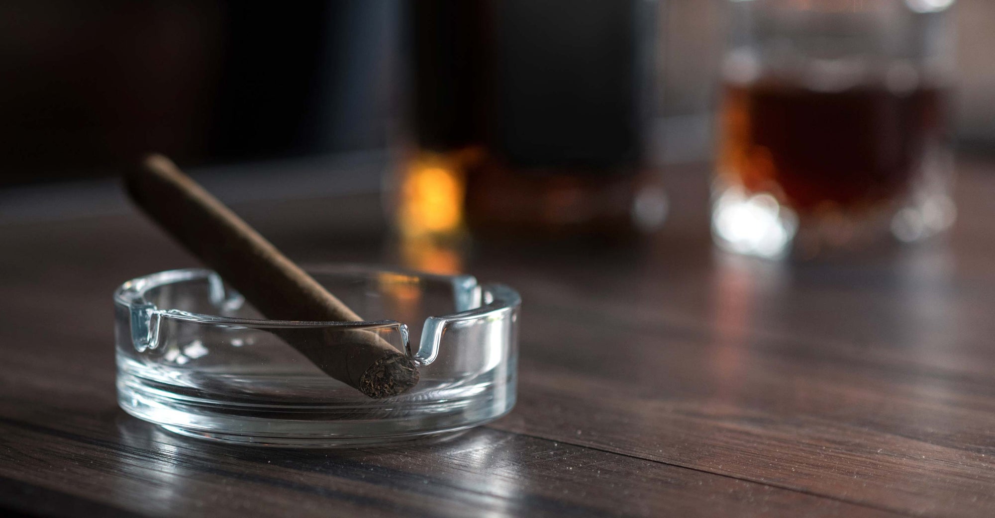 Cigar burning in an ashtray.