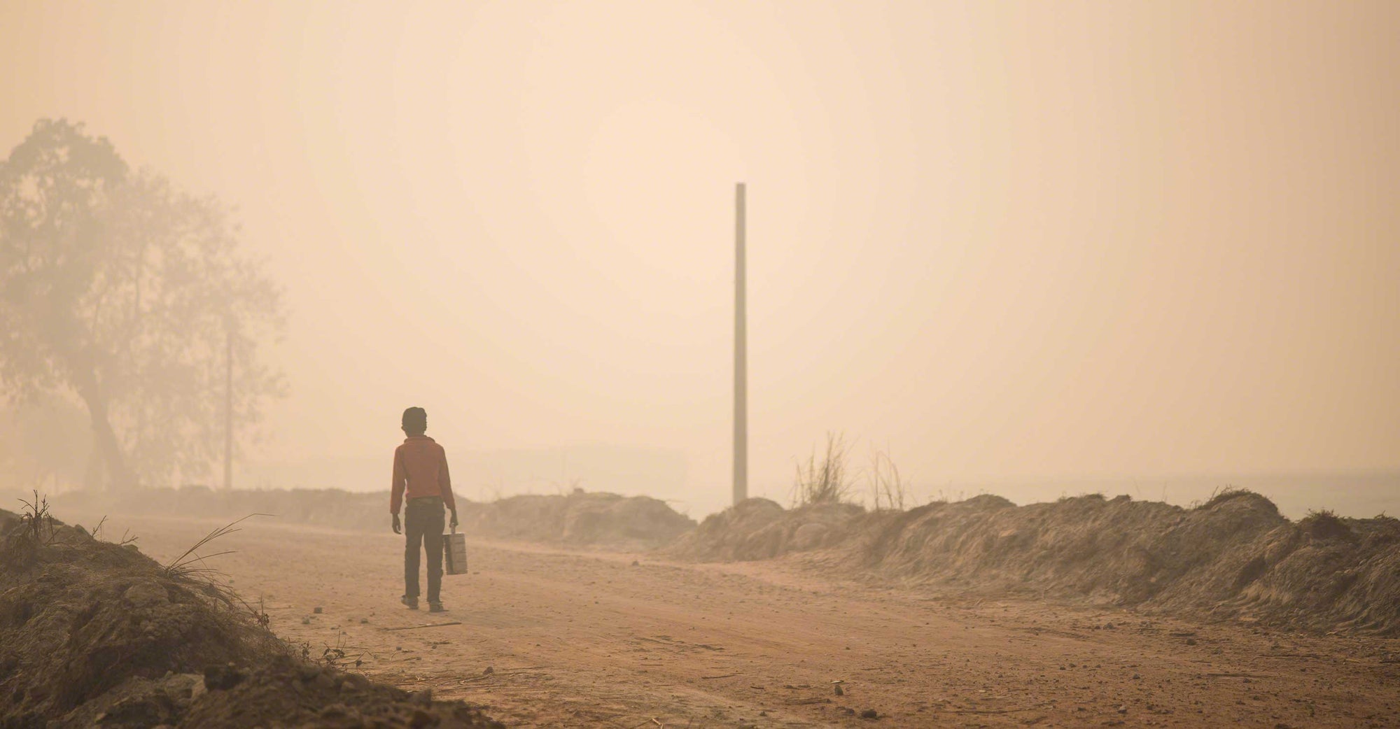 India smog and child walking down road