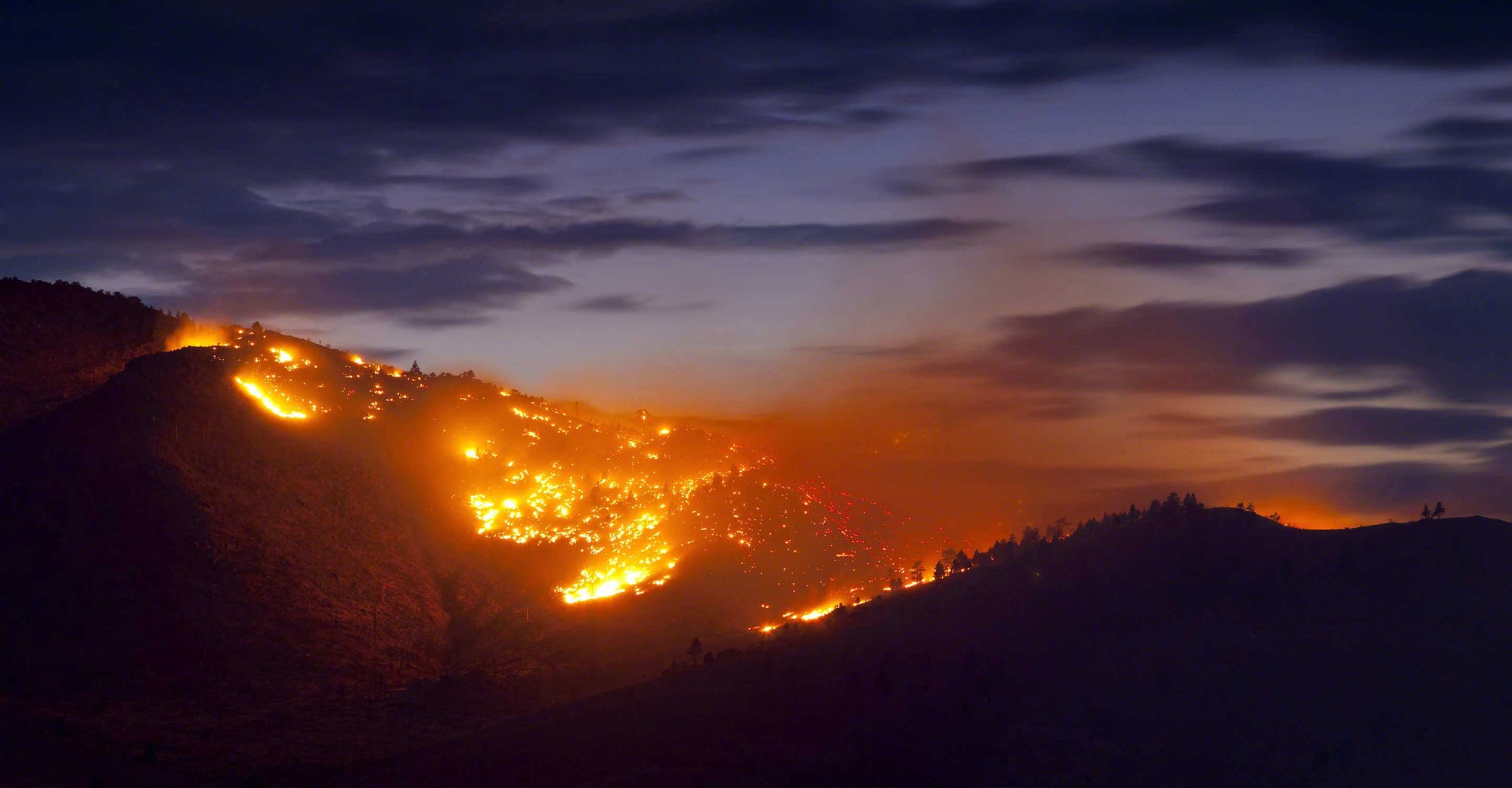 Wildfire at night in hills