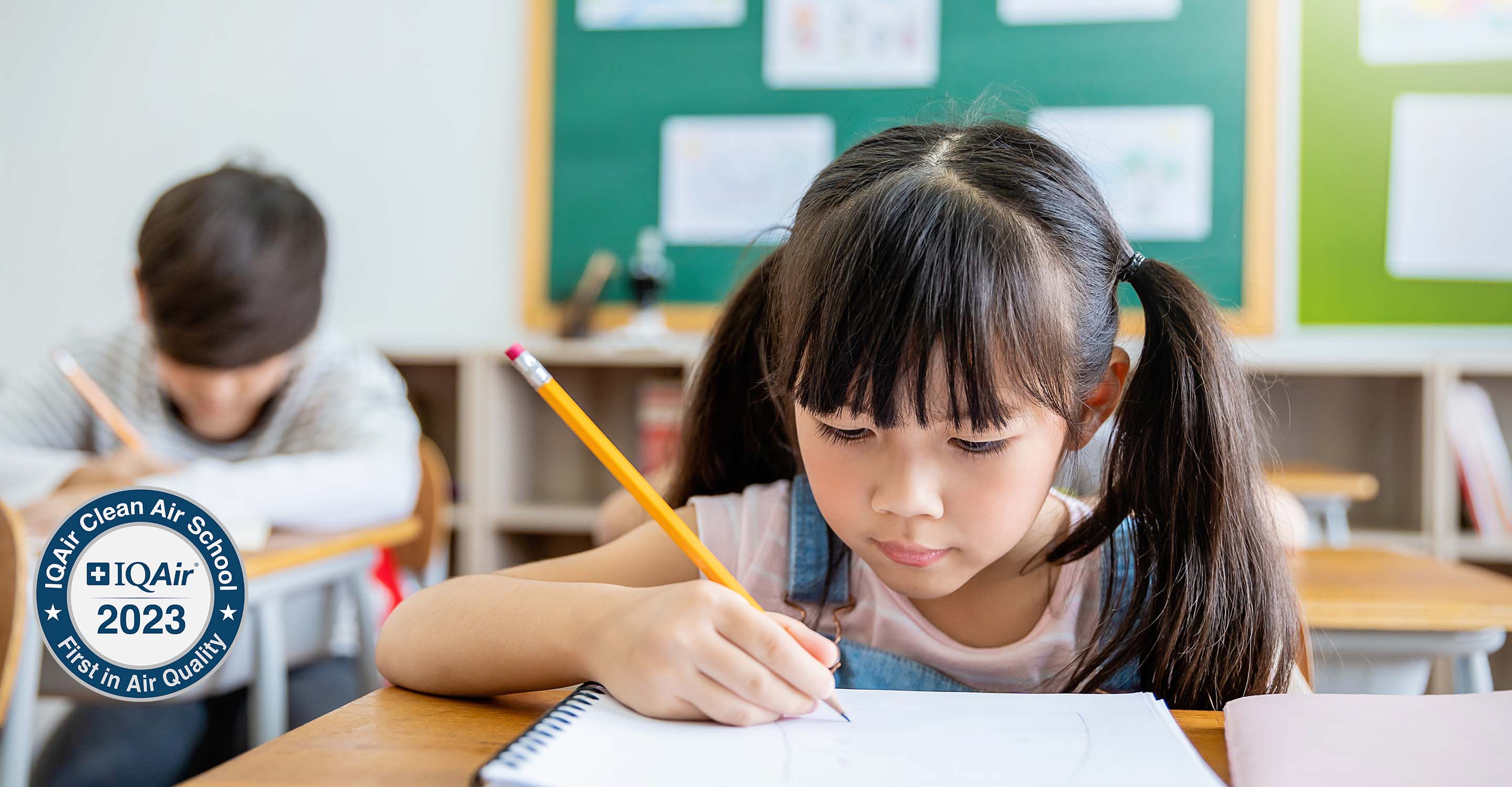 Child sitting at desk in a clean air school