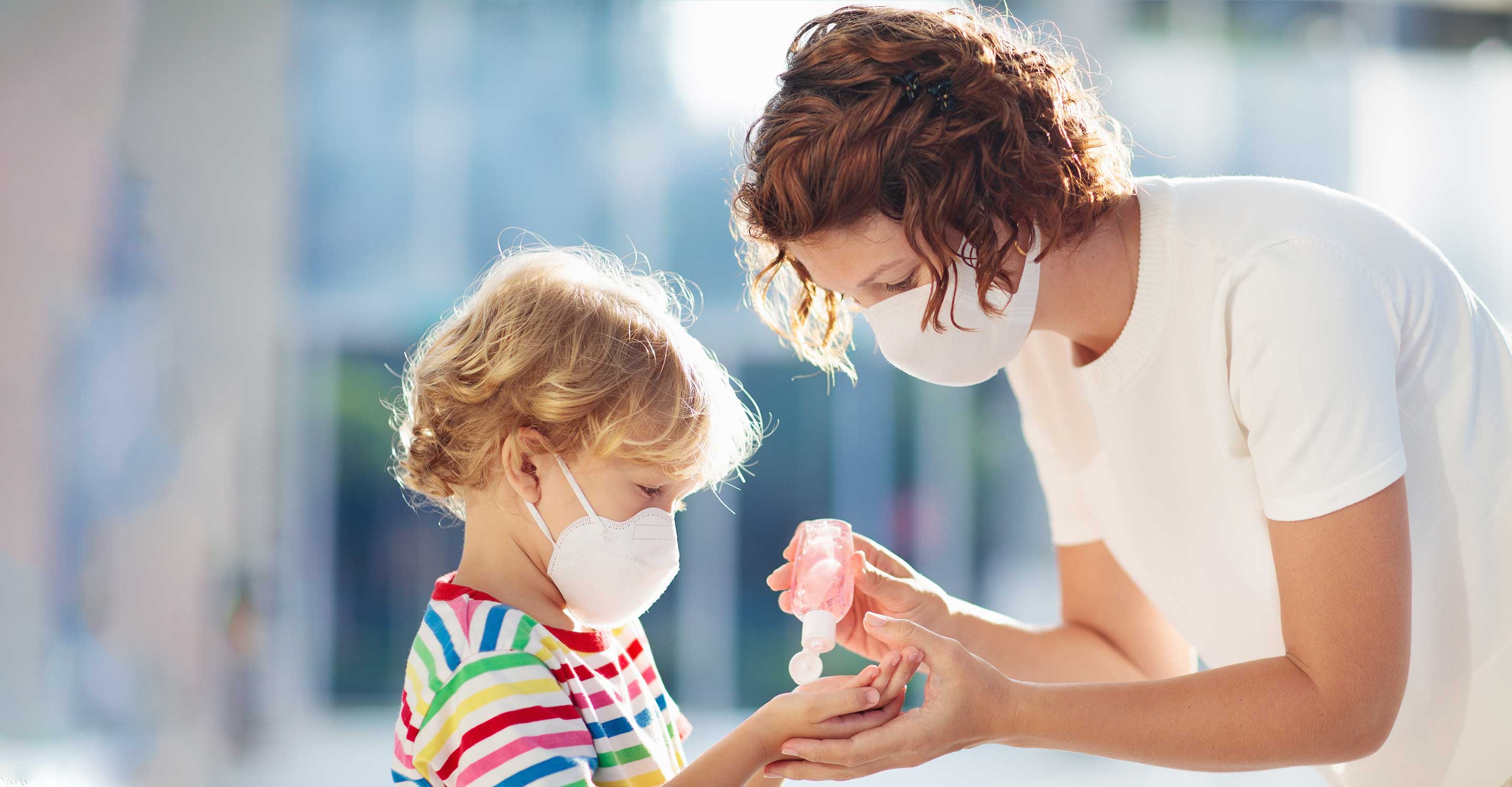 mother sanitizing her child's hand
