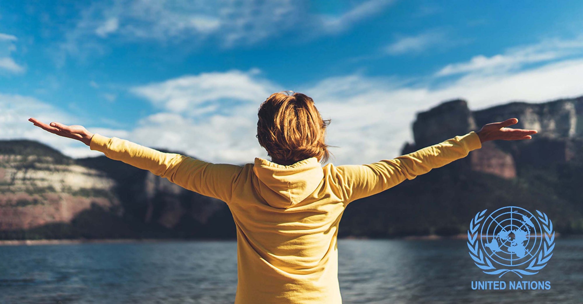 woman stretching her arms in front of a lake