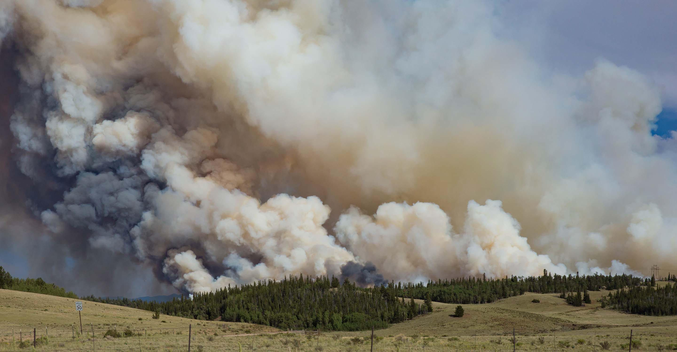 Smoke rising over woods and plains