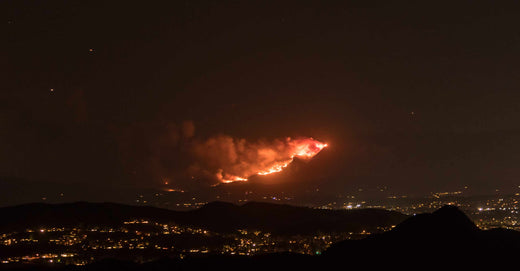 Fire on darkened hillside.