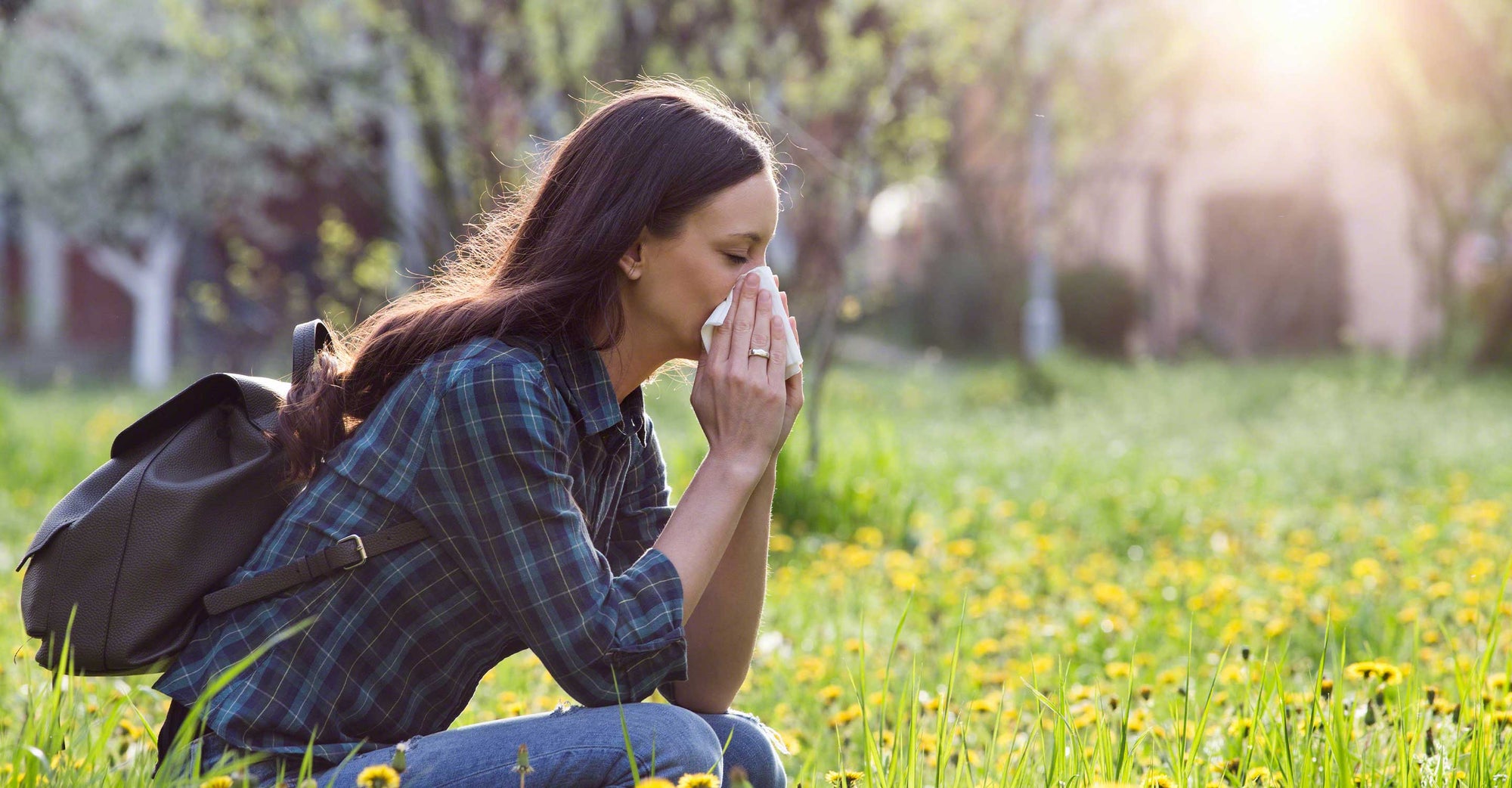 woman outside blowing her nose